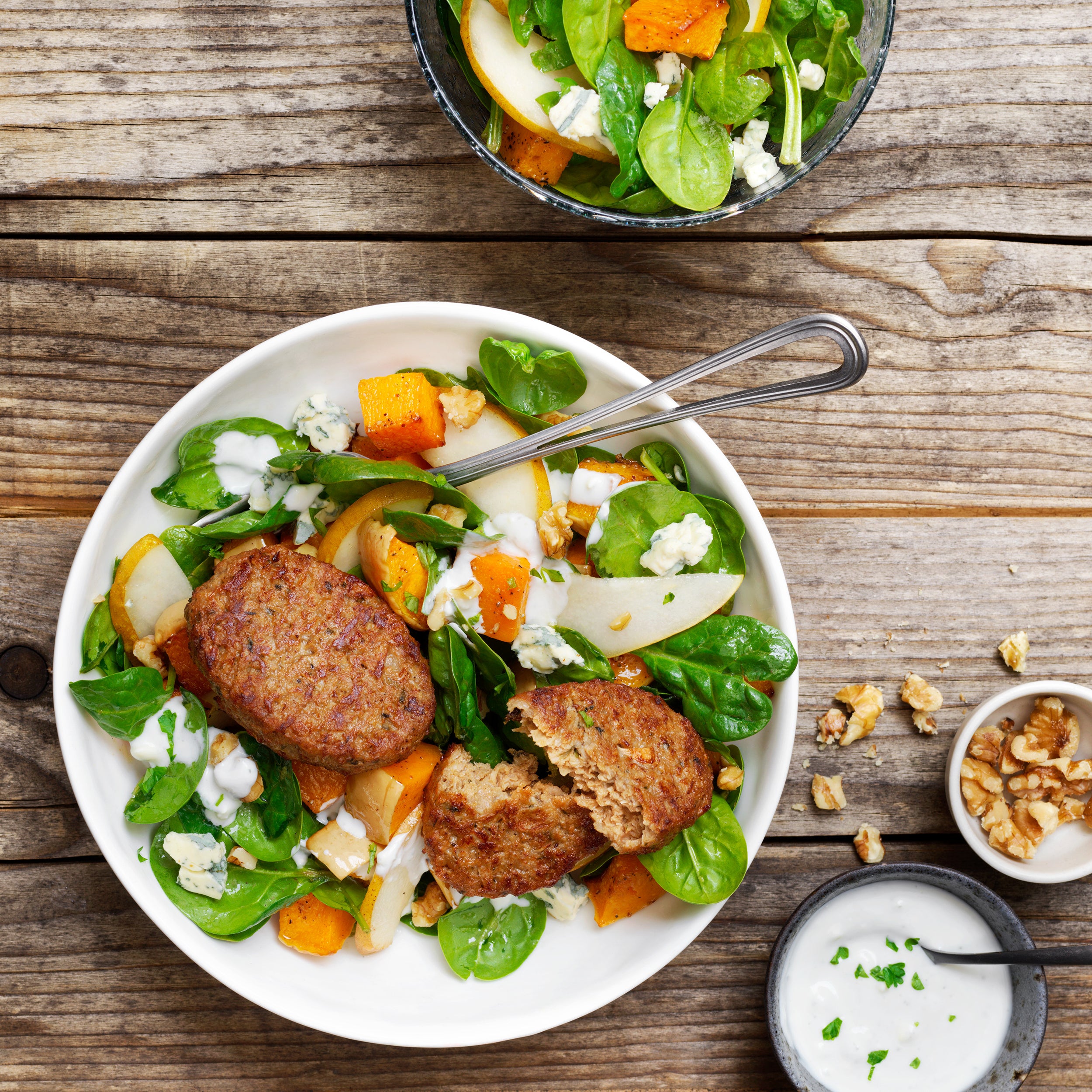 Gourmet Burger with mealsalad of spinach, roasted pumpki