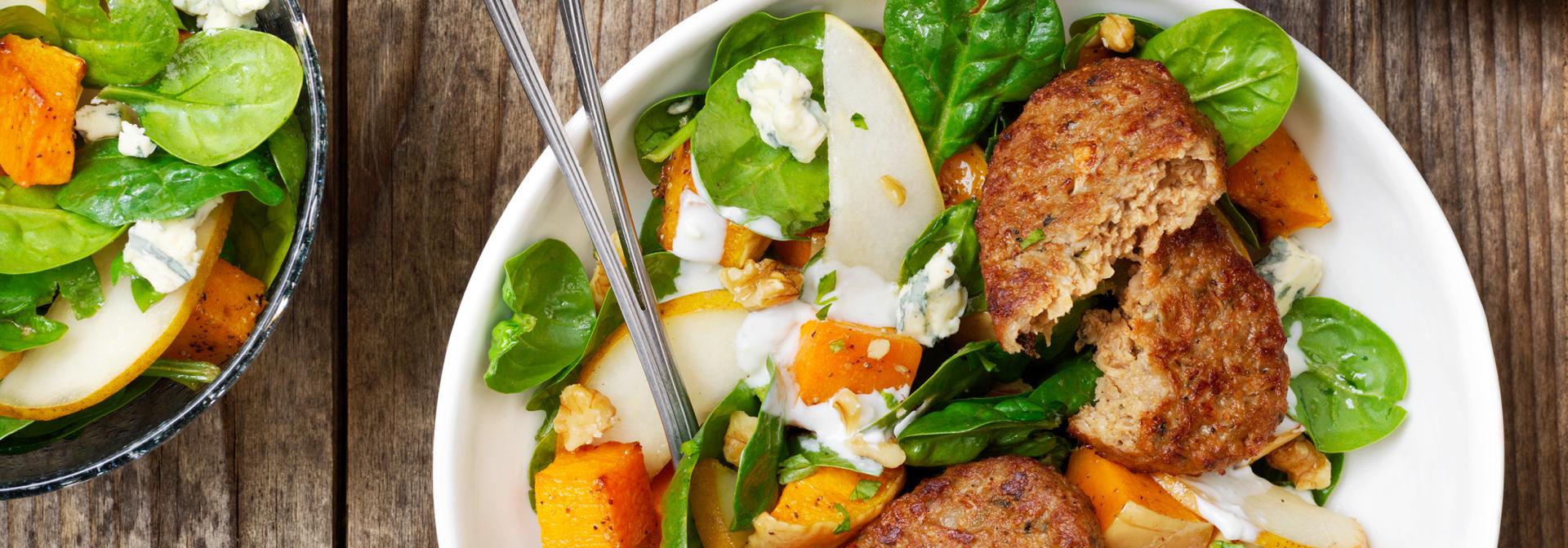 Gourmet Burger with mealsalad of spinach, roasted pumpki